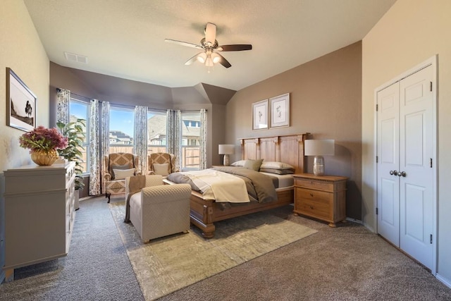 carpeted bedroom with vaulted ceiling and ceiling fan