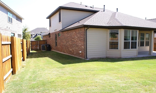 3264 Pablo Cir, Round Rock, TX 78665 - rear view of house with roof with shingles, brick siding, and a fenced backyard