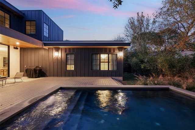 1702 Bauerle Ave, Austin, TX 78704 - pool at dusk with an outdoor pool, a wooden deck, and area for grilling