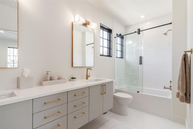 full bathroom with vanity, shower / bath combination with glass door, and toilet