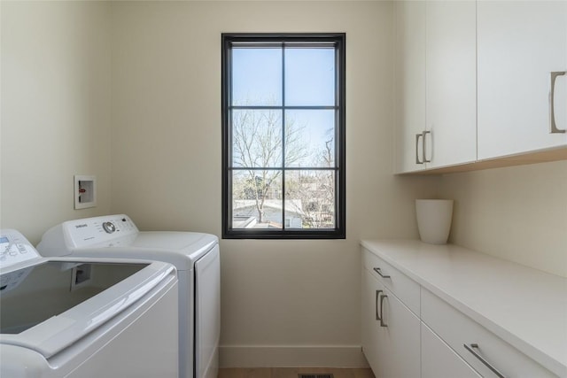1702 Bauerle Ave, Austin, TX 78704 - laundry room featuring washer and clothes dryer, cabinet space, and plenty of natural light