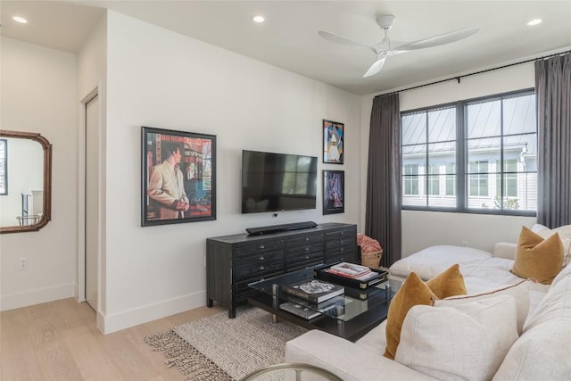 living room featuring ceiling fan and light wood-type flooring