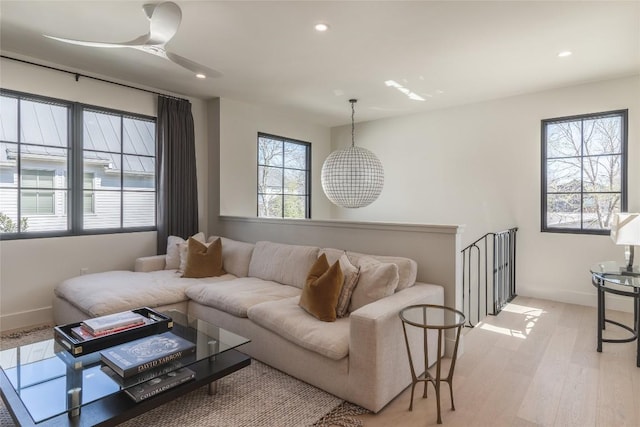 living room with ceiling fan and light wood-type flooring