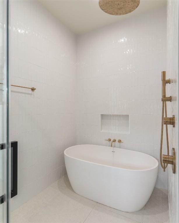 bathroom featuring tile patterned flooring, shower with separate bathtub, and tile walls