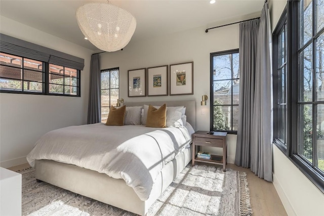 1702 Bauerle Ave, Austin, TX 78704 - bedroom featuring multiple windows and wood finished floors