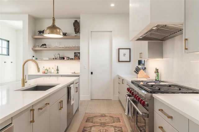 1702 Bauerle Ave, Austin, TX 78704 - kitchen with stainless steel appliances, premium range hood, light wood-style flooring, light countertops, and hanging light fixtures
