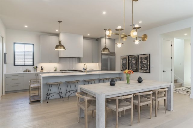 1702 Bauerle Ave, Austin, TX 78704 - kitchen featuring stainless steel built in fridge, gray cabinetry, light countertops, light wood-style floors, and recessed lighting