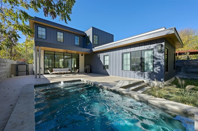 1702 Bauerle Ave, Austin, TX 78704 - rear view of property with board and batten siding, a fenced backyard, and a jacuzzi