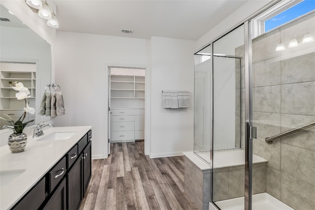 bathroom featuring vanity, hardwood / wood-style flooring, and walk in shower