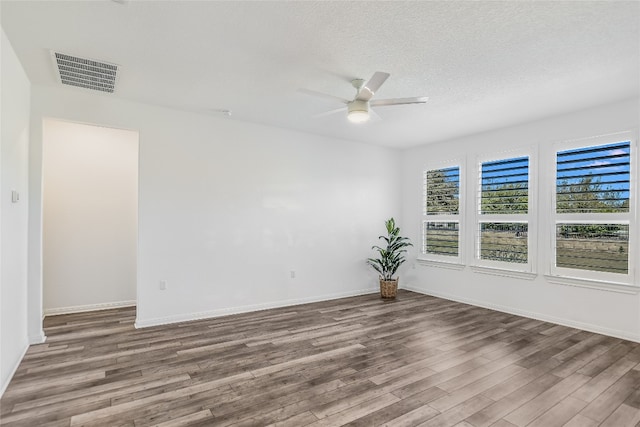 spare room featuring hardwood / wood-style floors, a textured ceiling, and ceiling fan