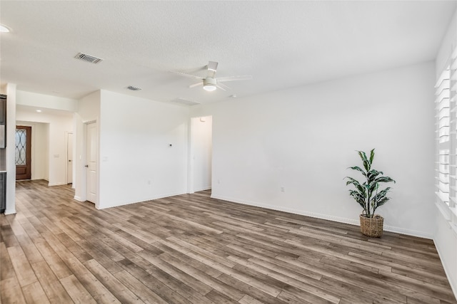 unfurnished room with ceiling fan, hardwood / wood-style floors, and a textured ceiling