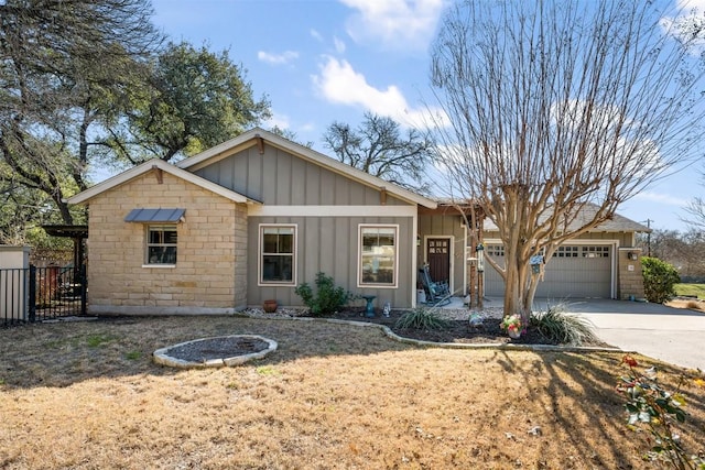 ranch-style home featuring board and batten siding, driveway, a garage, and fence