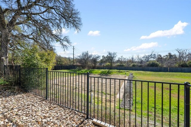 view of gate featuring a yard