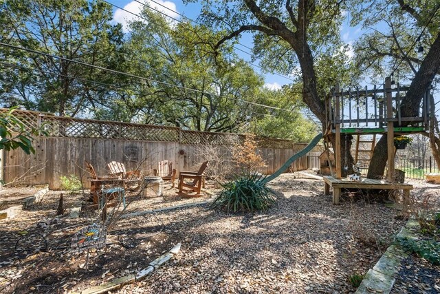 view of yard featuring a playground and a fire pit