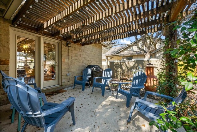 view of patio featuring area for grilling and a pergola