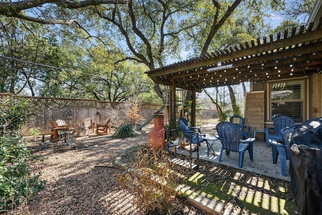 view of yard with a patio and an outdoor fire pit