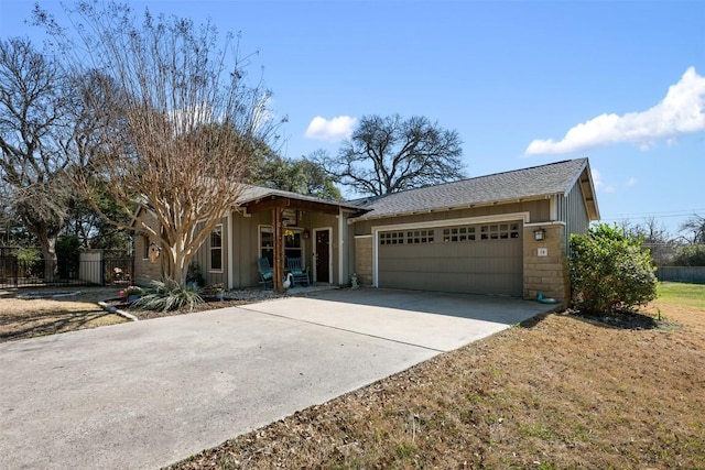 single story home with a garage, board and batten siding, driveway, and fence