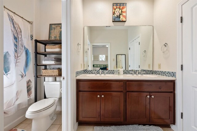 full bathroom with tile patterned flooring, vanity, shower / bathtub combination with curtain, and toilet