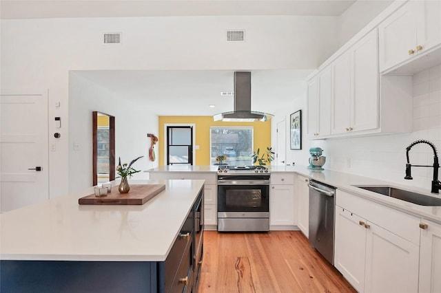 kitchen featuring white cabinetry, appliances with stainless steel finishes, sink, and island range hood