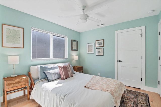 bedroom with ceiling fan and light wood-type flooring