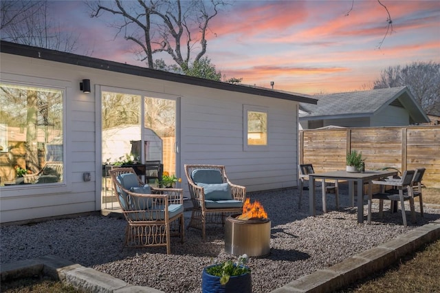 back house at dusk featuring a fire pit