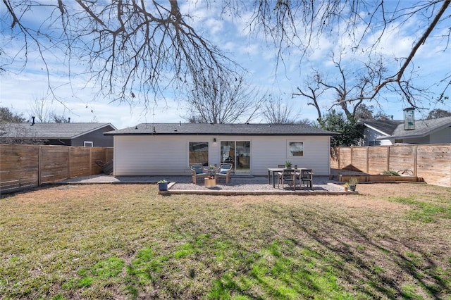 rear view of house with a patio and a yard