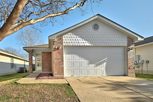 7405 Cayenne Ln, Austin, TX 78741 - ranch-style house with brick siding, a garage, concrete driveway, and central air condition unit