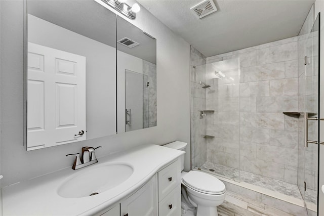 bathroom with vanity, an enclosed shower, and toilet