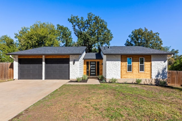 single story home with a garage and a front lawn