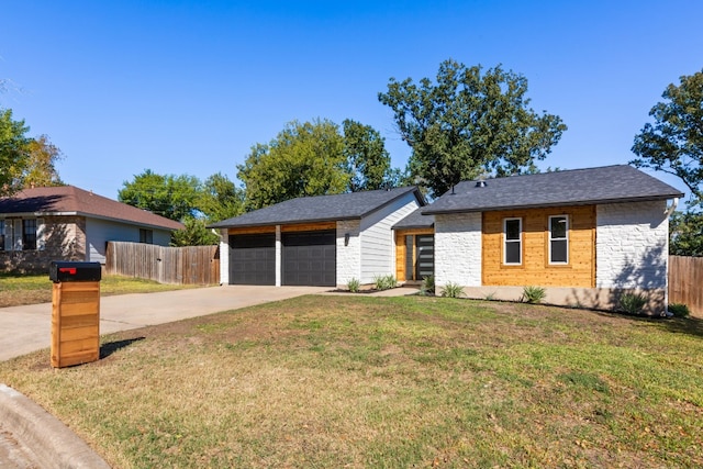 single story home featuring a garage and a front yard