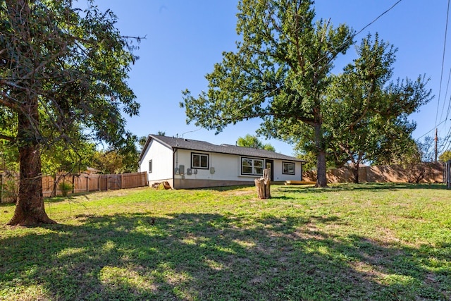 rear view of property with a yard