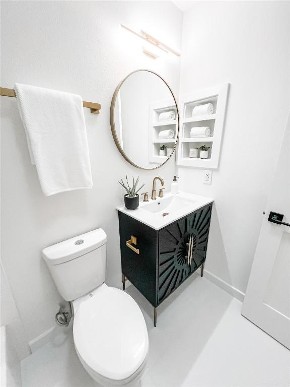 bathroom featuring vanity and toilet