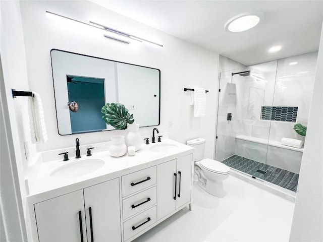 bathroom featuring toilet, vanity, and walk in shower