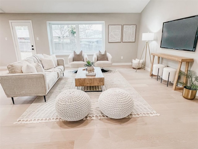 living room featuring plenty of natural light and light hardwood / wood-style floors