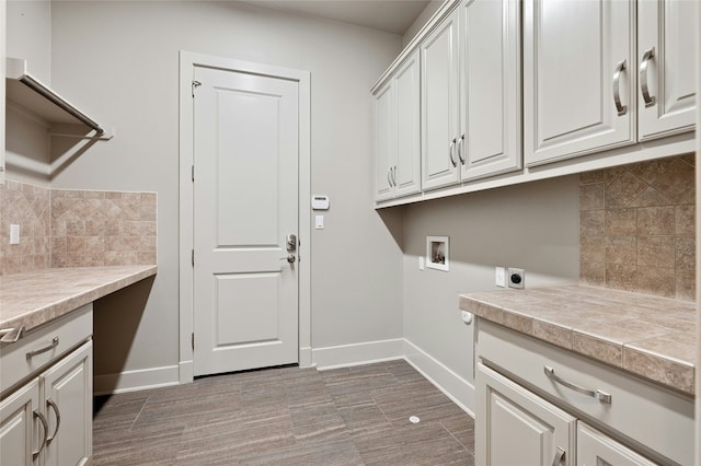 washroom featuring cabinets, hookup for a washing machine, and electric dryer hookup