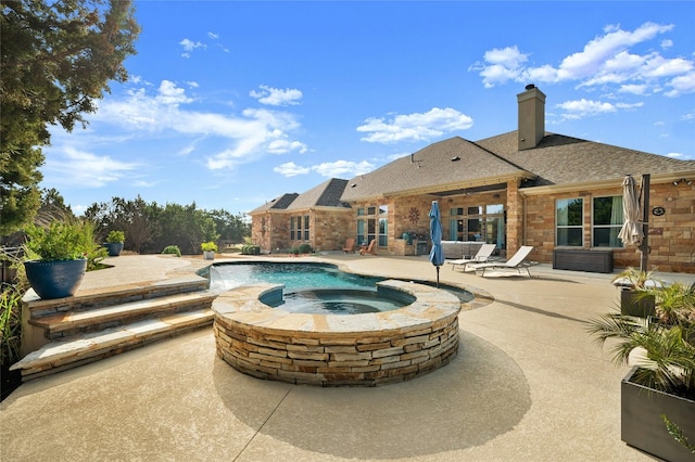 view of pool with an in ground hot tub and a patio