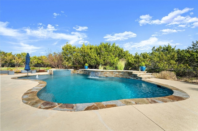 view of pool featuring pool water feature and a patio area