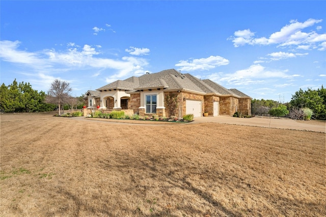 view of front of home with a garage and a front lawn