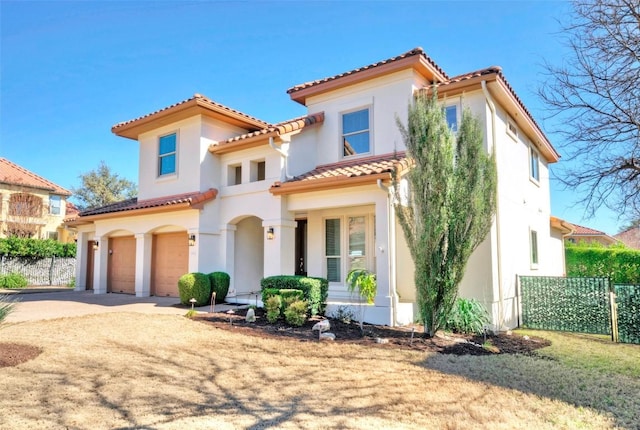 mediterranean / spanish house with a garage