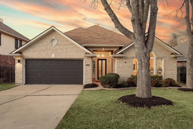 view of front facade featuring a garage and a lawn