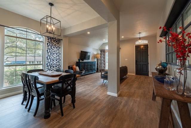 dining area featuring hardwood / wood-style flooring and a chandelier