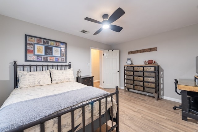 bedroom with ceiling fan and light hardwood / wood-style flooring