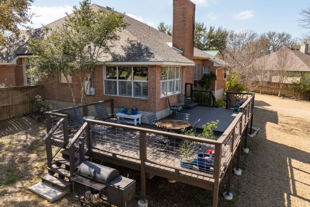 rear view of house with a wooden deck