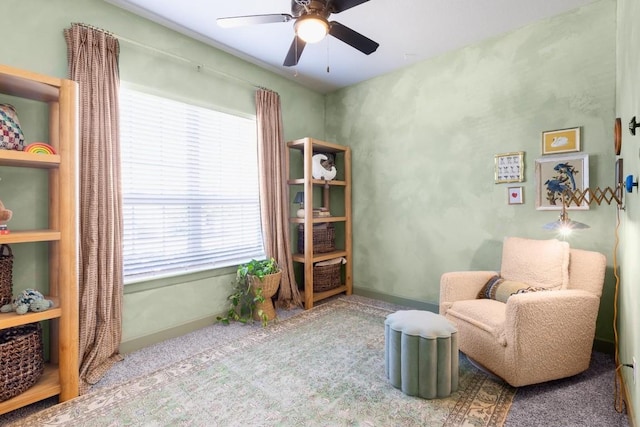 sitting room featuring ceiling fan