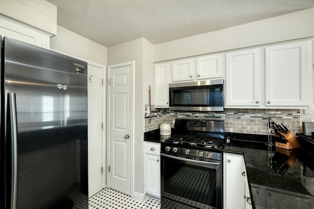 kitchen with white cabinetry, decorative backsplash, and appliances with stainless steel finishes