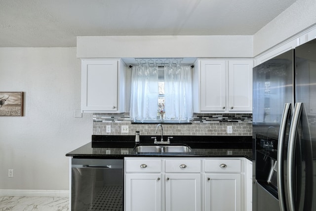 kitchen with stainless steel appliances, white cabinetry, and sink