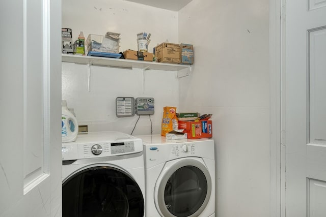 clothes washing area featuring independent washer and dryer