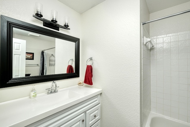 bathroom featuring vanity and shower / bathtub combination with curtain