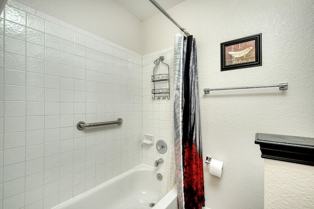 bathroom with shower / bath combo with shower curtain