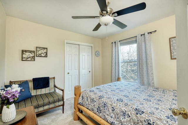 bedroom featuring ceiling fan, light colored carpet, and a closet